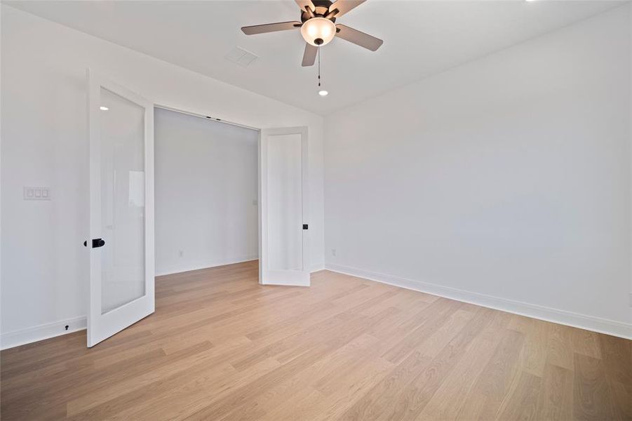 Unfurnished bedroom featuring ceiling fan, a closet, and light hardwood / wood-style floors