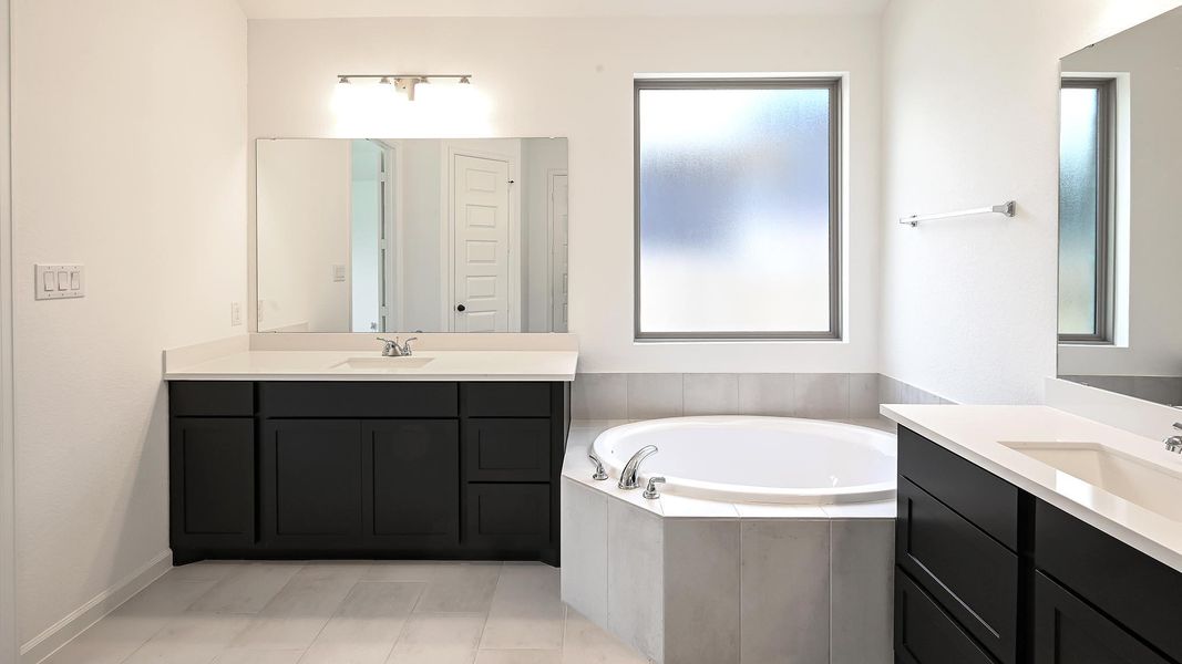 Bathroom with a bath, two vanities, and light tile patterned floors Bathroom with a bath, two vanities, and light tile patterned floors