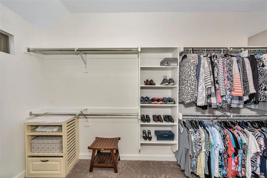 Spacious closet with carpet floors