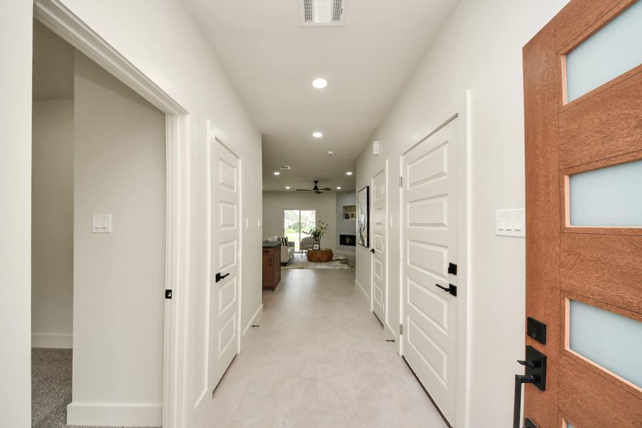 Contemporary front door design with sleek hardware sets the tone for the interior.