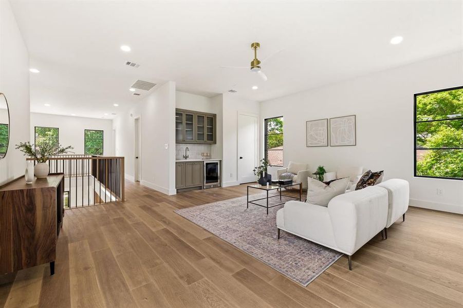 Secondary living space with built in wine cooler, wet bar, access to 2nd laundry room