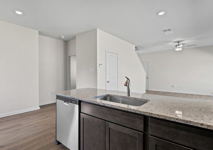 The kitchen looks out into the family room.