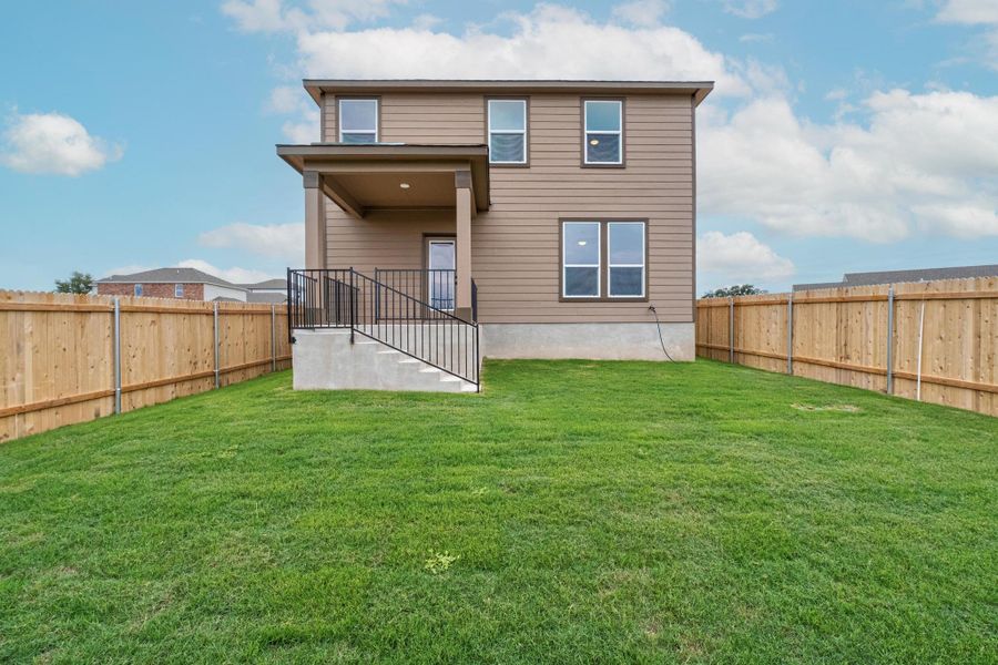 Front exterior of a new home in Creekside at Estancia, Austin, TX, highlighting curb appeal (Image 16).