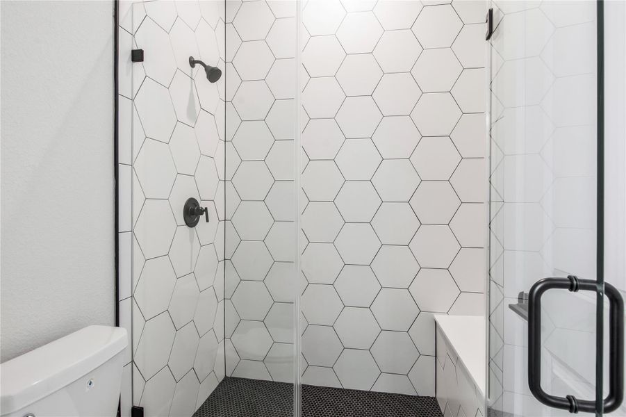 Elegant tile design elevates the secondary bathroom. Elegant tile design elevates the secondary bathroom.