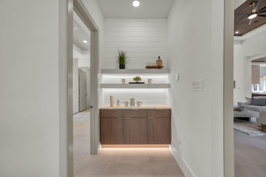 The primary suite comes with a lighted coffee bar and built in shelves to complete your tranquil retreat.