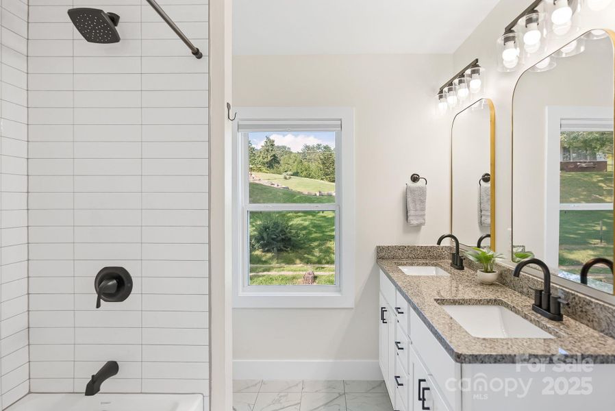 Primary ensuite bathroom with tile shower