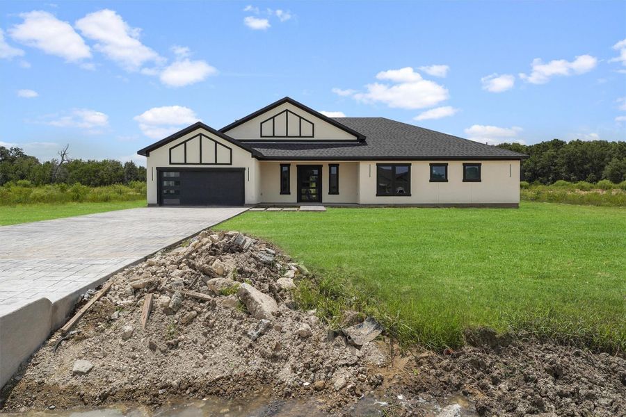 Front exterior of a new home in , Dayton, TX, highlighting curb appeal (Image 2). Front exterior of a new home in , Dayton, TX, highlighting curb appeal (Image 2).