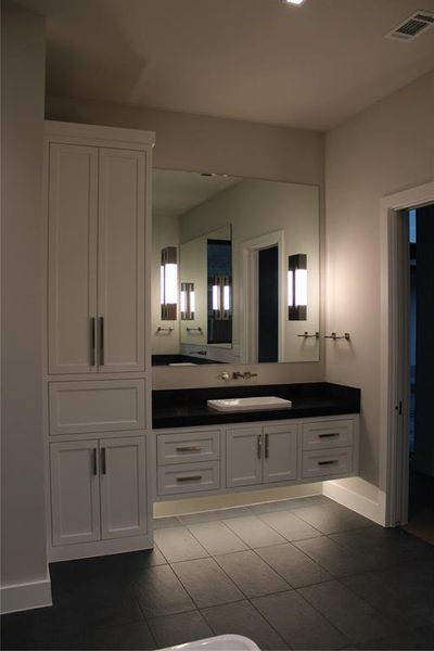 Bathroom featuring tile patterned flooring and vanity