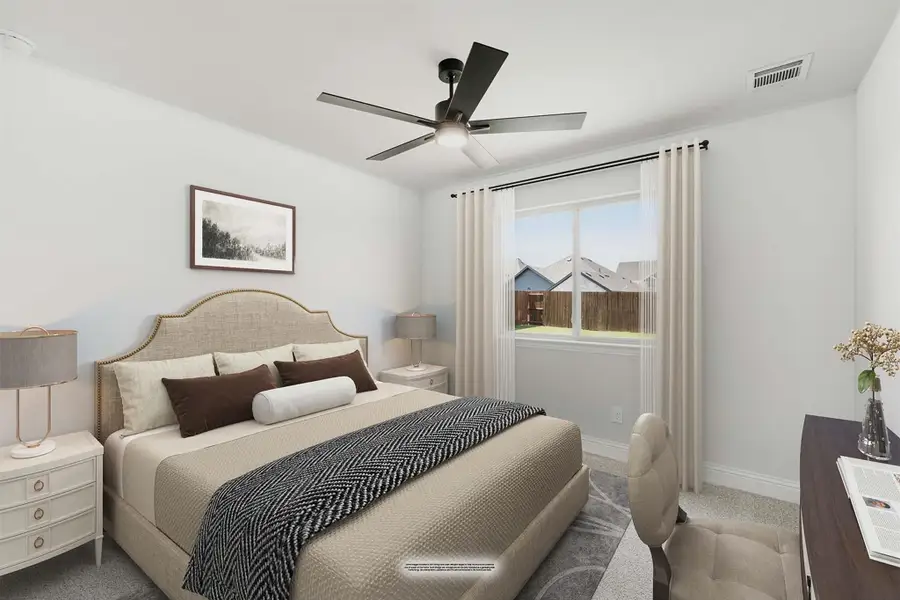 Bedroom with upholstered headboard, ceiling fan, carpet flooring, and a window with neutral drapes Bedroom with upholstered headboard, ceiling fan, carpet flooring, and a window with neutral drapes