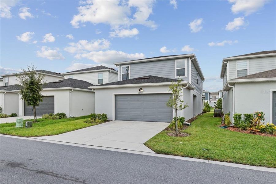 Front exterior of a new home in EverBe, Orlando, FL, highlighting curb appeal (Image 19).