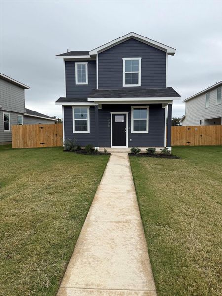 Front exterior of a new home in Valverde, Bastrop, TX, highlighting curb appeal (Image 2).