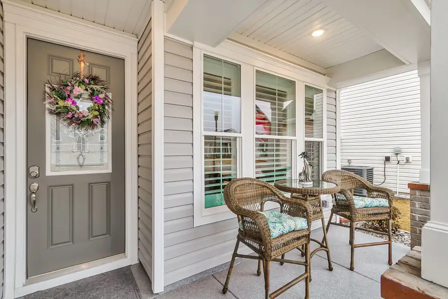Exterior details and patio area of a home in K. Hovnanian's® Four Seasons at Lakes of Cane Bay, Summerville (Image 4).