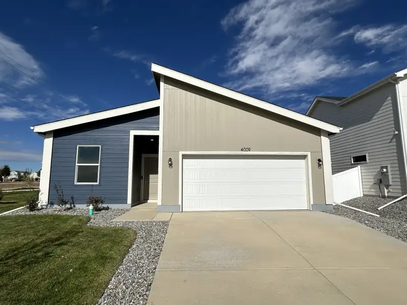 Front exterior of a new home in Liberty Draw, Evans, CO, highlighting curb appeal (Image 2). Front exterior of a new home in Liberty Draw, Evans, CO, highlighting curb appeal (Image 2).