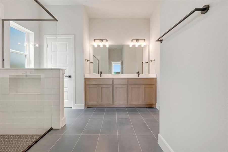 Dual vanity with light wood-finish cabinetry and rectangular sinks