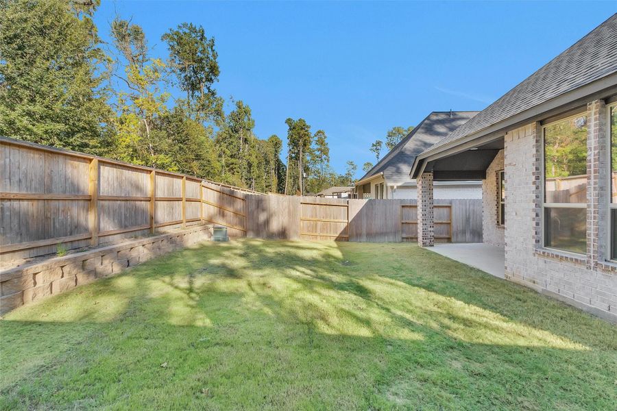 Exterior details and patio area of a home in Woodforest 40', Montgomery (Image 26).