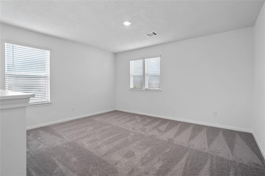 Come upstairs and enjoy a day of leisure in this fabulous game room! This is the perfect hangout spot or adult game room, this space features plush carpet, high ceiling, recessed lighting and custom paint.