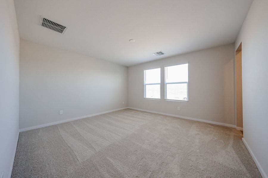 A room with a carpet and windows. A room with a carpet and windows.