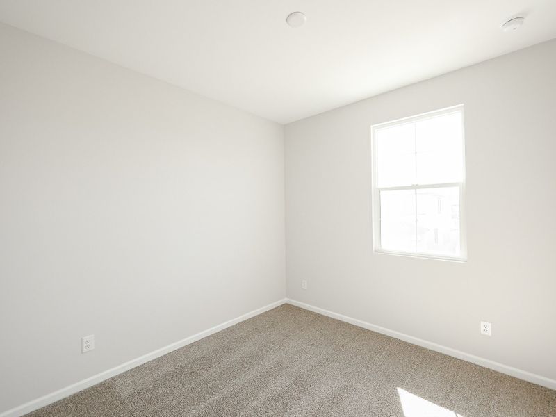 A room with a window and a carpet. A room with a window and a carpet.