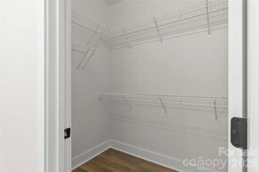 Primary bedroom walk in closet