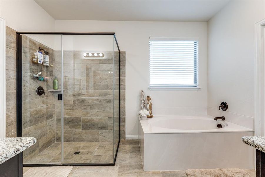 Bathroom with independent shower and bath, tile patterned flooring, and vanity