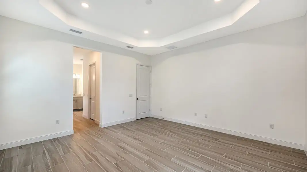 Spacious, unfurnished interior of a new home in Palm Grove Real Estate and Homes for Sale in Lakewood Ranch, FL - Neal Communities, Bradenton (Image 27).