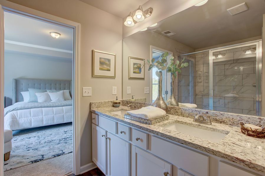 Luxurious primary bathroom with dual vanities