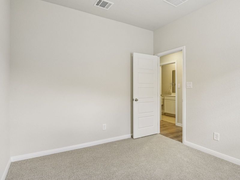 Guest bedroom in the Oleander floorplan at a Meritage Homes community.
