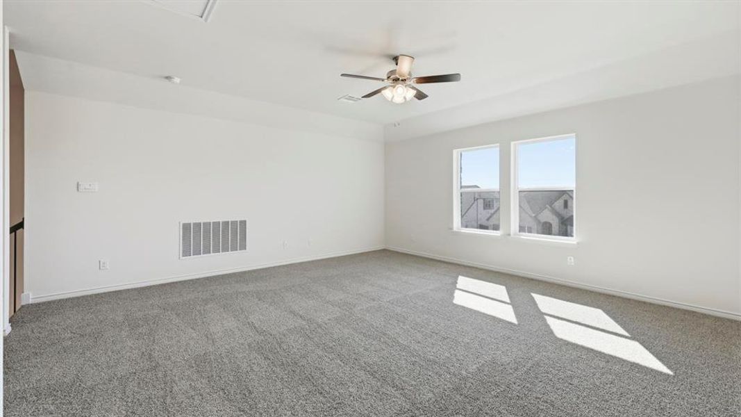 Unfurnished room featuring carpet flooring and a ceiling fan Unfurnished room featuring carpet flooring and a ceiling fan