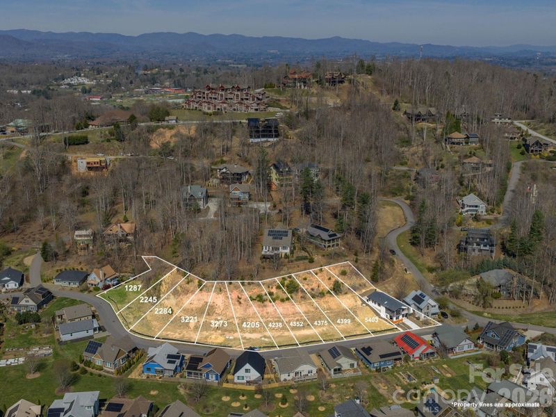 Aerial view of the Courtyard Villas offering, highlighting the completed villa and additional lots available as proposed construction land/home packages, with 48 Verde Drive identified as Lot #5403.