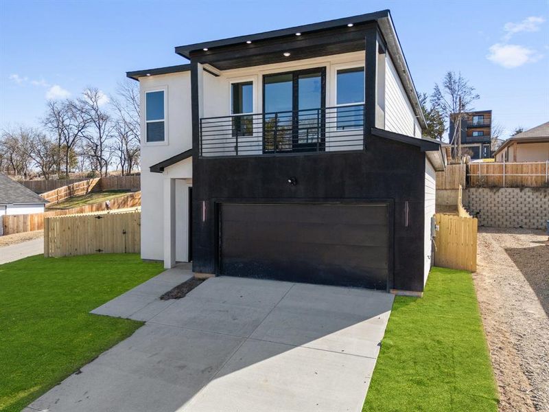 Modern home with a garage and a front lawn