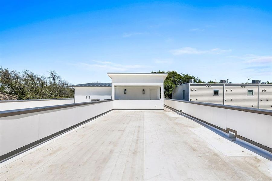 View of patio with a balcony