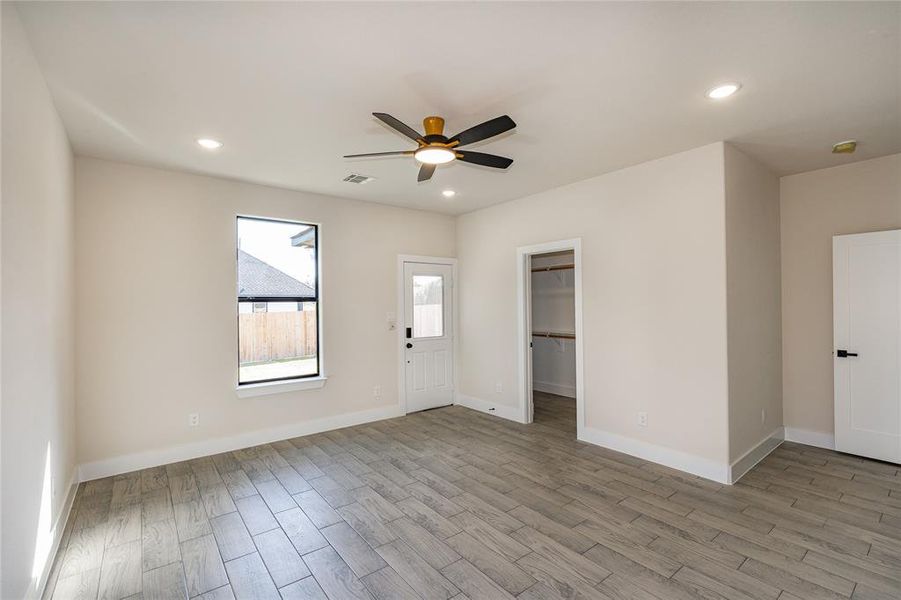 Bedroom featuring light hardwood / wood-style floors and ceiling fan