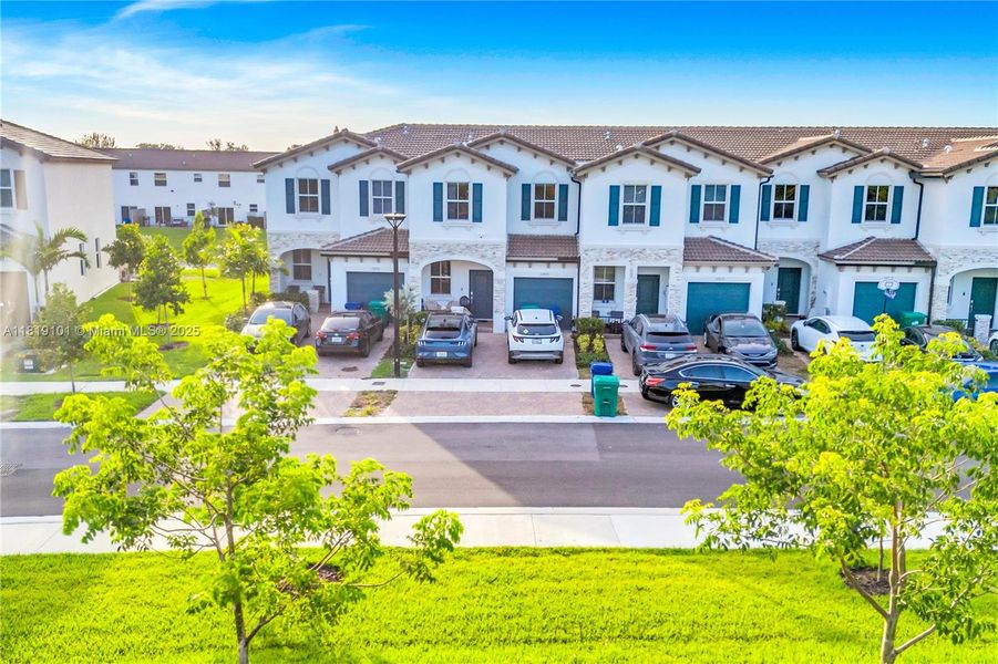 Front exterior of a new home in Westview: Nantucket Collection, Miami, FL, highlighting curb appeal (Image 24). Front exterior of a new home in Westview: Nantucket Collection, Miami, FL, highlighting curb appeal (Image 24).