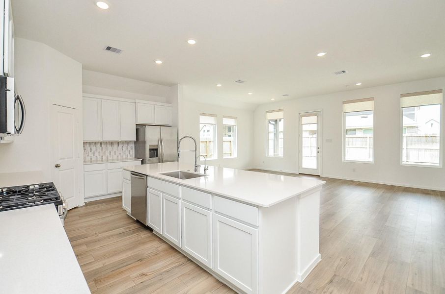 Another view of the kitchen and open concept floorplan! Check out all of that natural light!
