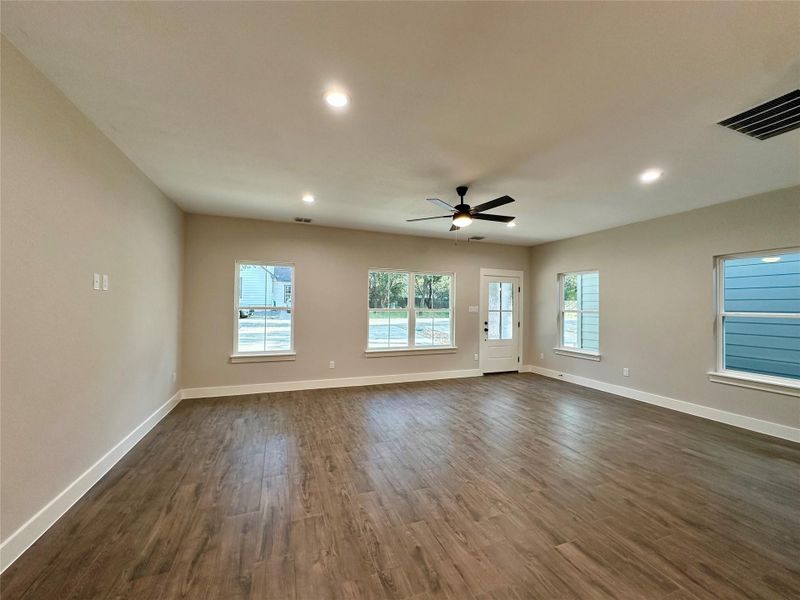 Unfurnished living room with dark wood-style flooring, recessed lighting, and a ceiling fan
