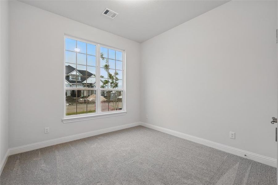 Empty room with carpet floors and baseboards