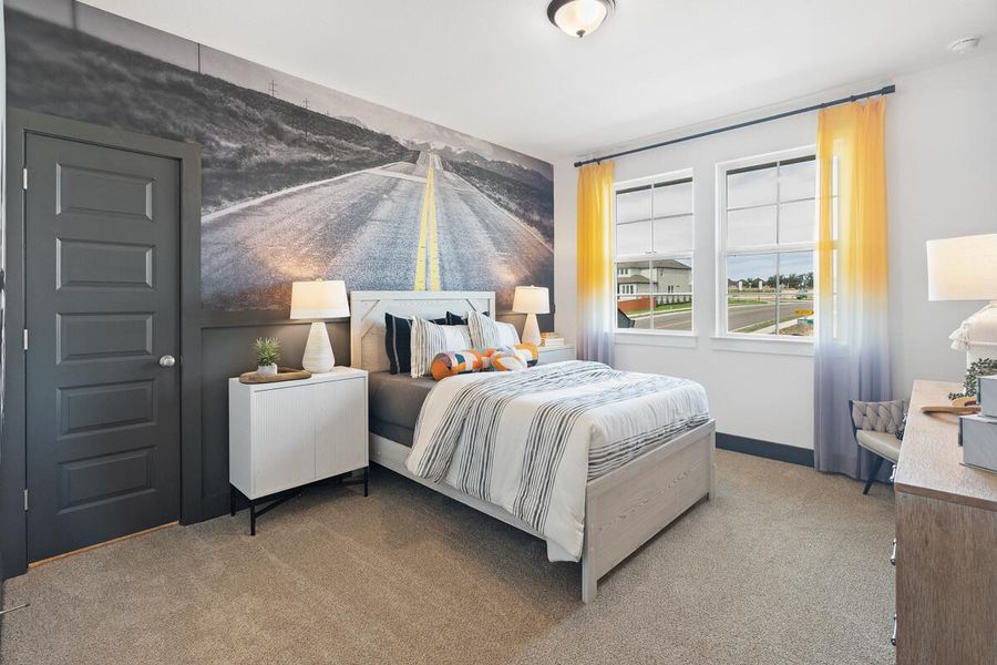 Carpeted bedroom with baseboards and an accent wall