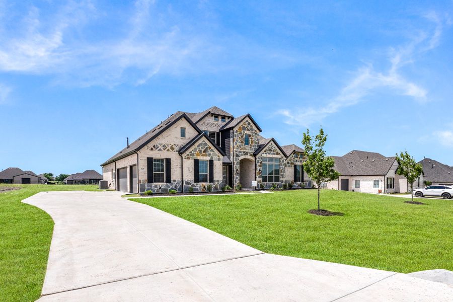 Front exterior of a new home in Heritage, McLendon-Chisholm, TX, highlighting curb appeal (Image 14).