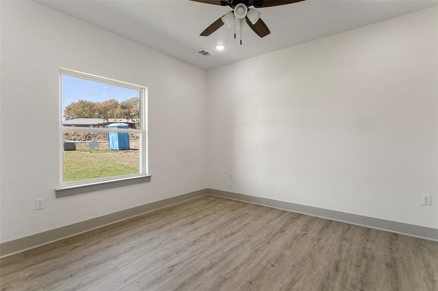 Spare room with ceiling fan and light wood-type flooring