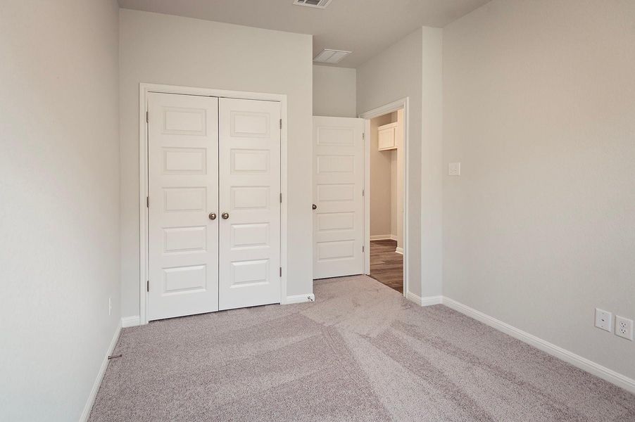 Unfurnished bedroom featuring carpet floors, a closet, and baseboards Unfurnished bedroom featuring carpet floors, a closet, and baseboards
