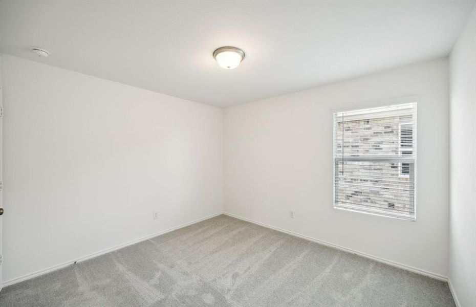 Spacious secondary bedroom with ample closet space*real home pictured