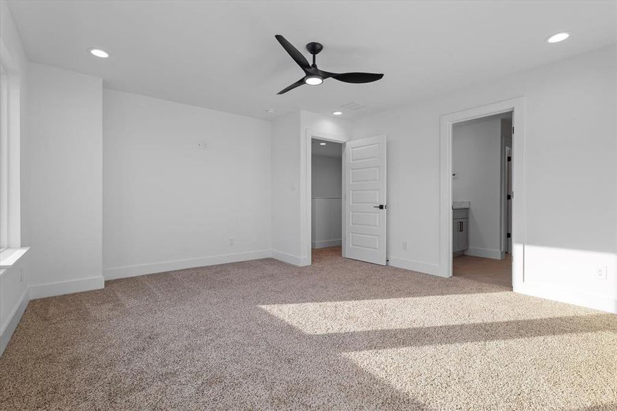 Unfurnished bedroom featuring recessed lighting, light colored carpet, ceiling fan, and ensuite bathroom Unfurnished bedroom featuring recessed lighting, light colored carpet, ceiling fan, and ensuite bathroom