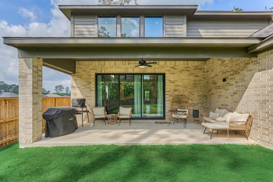 This inviting patio features comfortable seating for outdoor cooking, and a custom doggy door, perfect for seamless indoor-outdoor living for both you and your pets.