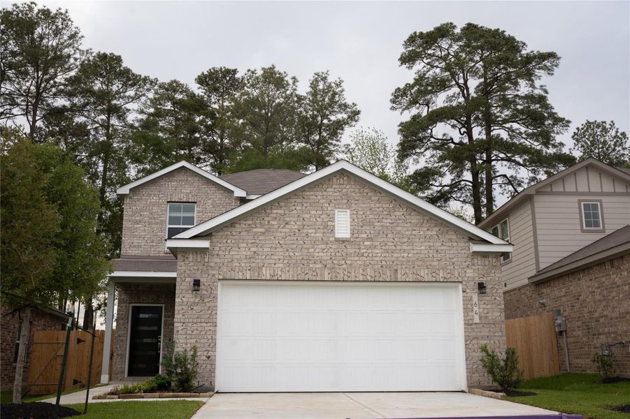 Front exterior of a new home in Lakes at Black Oak, Magnolia, TX, highlighting curb appeal (Image 2).