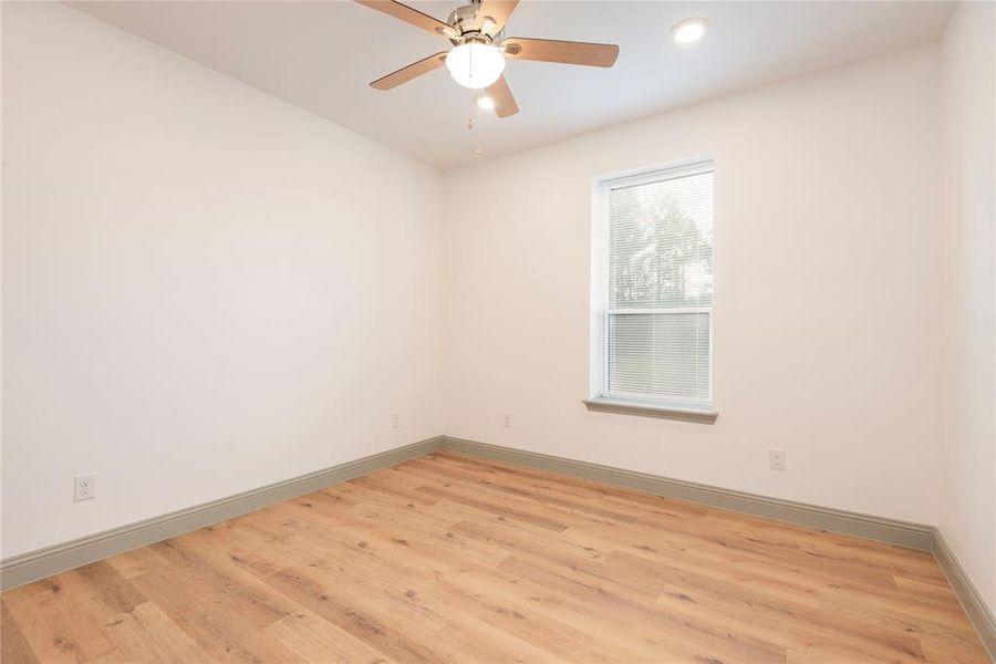 Empty room with light wood-style flooring, a ceiling fan, and recessed lighting