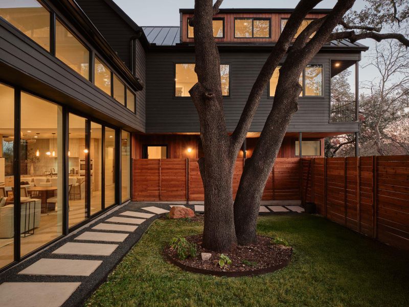 Back of house featuring a fenced backyard and a standing seam roof