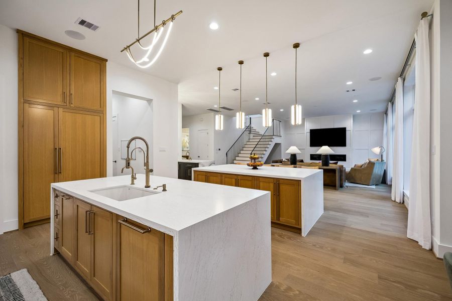 Looking into the den from the breakfast room, this view highlights the home’s open layout and refined elegance.