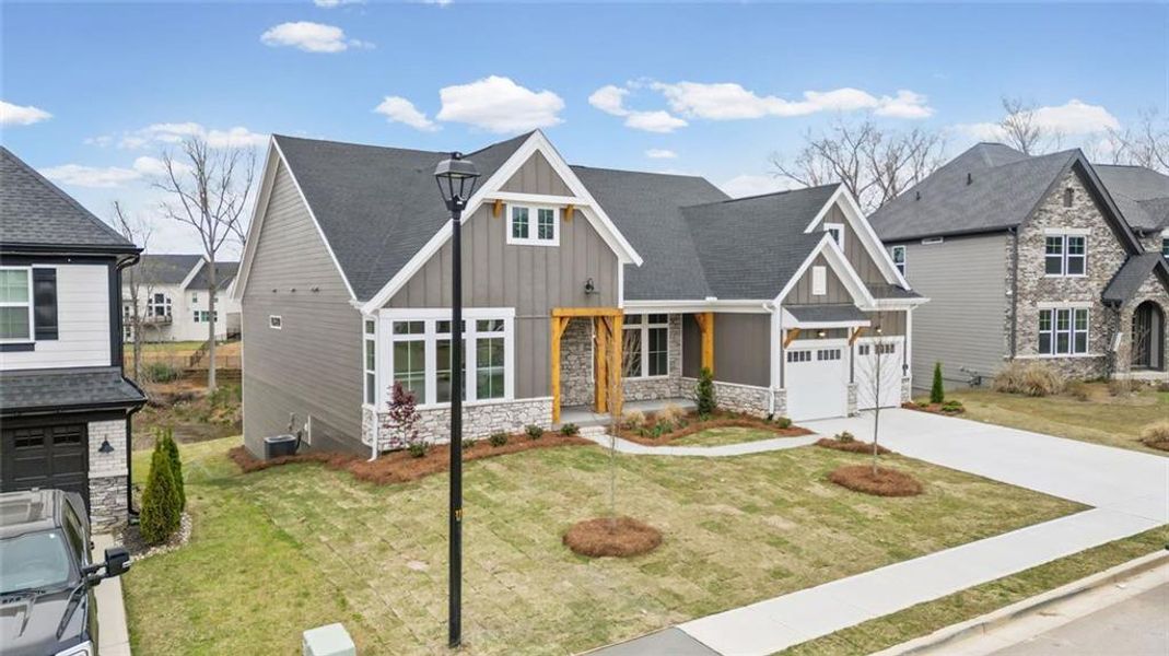 Front exterior of a new home in Twin Lakes, Hoschton, GA, highlighting curb appeal (Image 22). Front exterior of a new home in Twin Lakes, Hoschton, GA, highlighting curb appeal (Image 22).