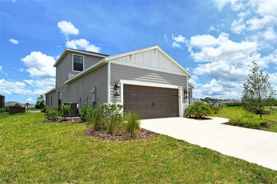 Front exterior of a new home in Canoe Creek, Parrish, FL, highlighting curb appeal (Image 27).