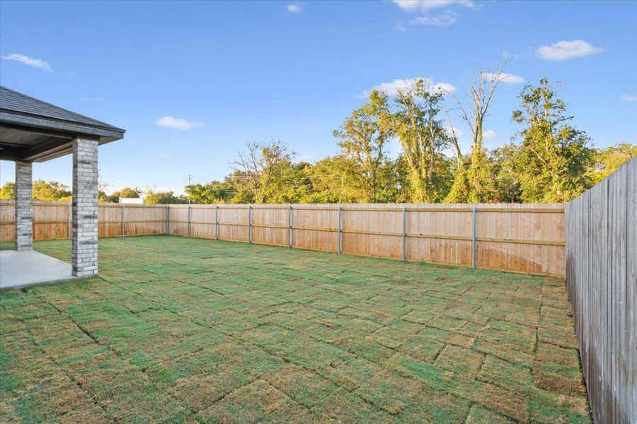Fenced backyard featuring a patio area Fenced backyard featuring a patio area